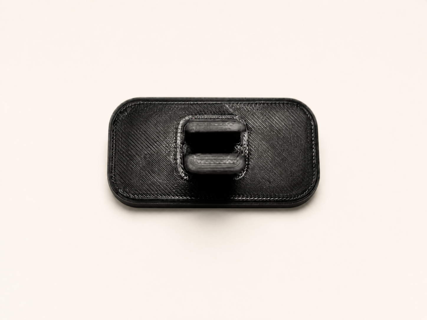 Back of the included 3D-printed Dash Badge showing the mounting clip