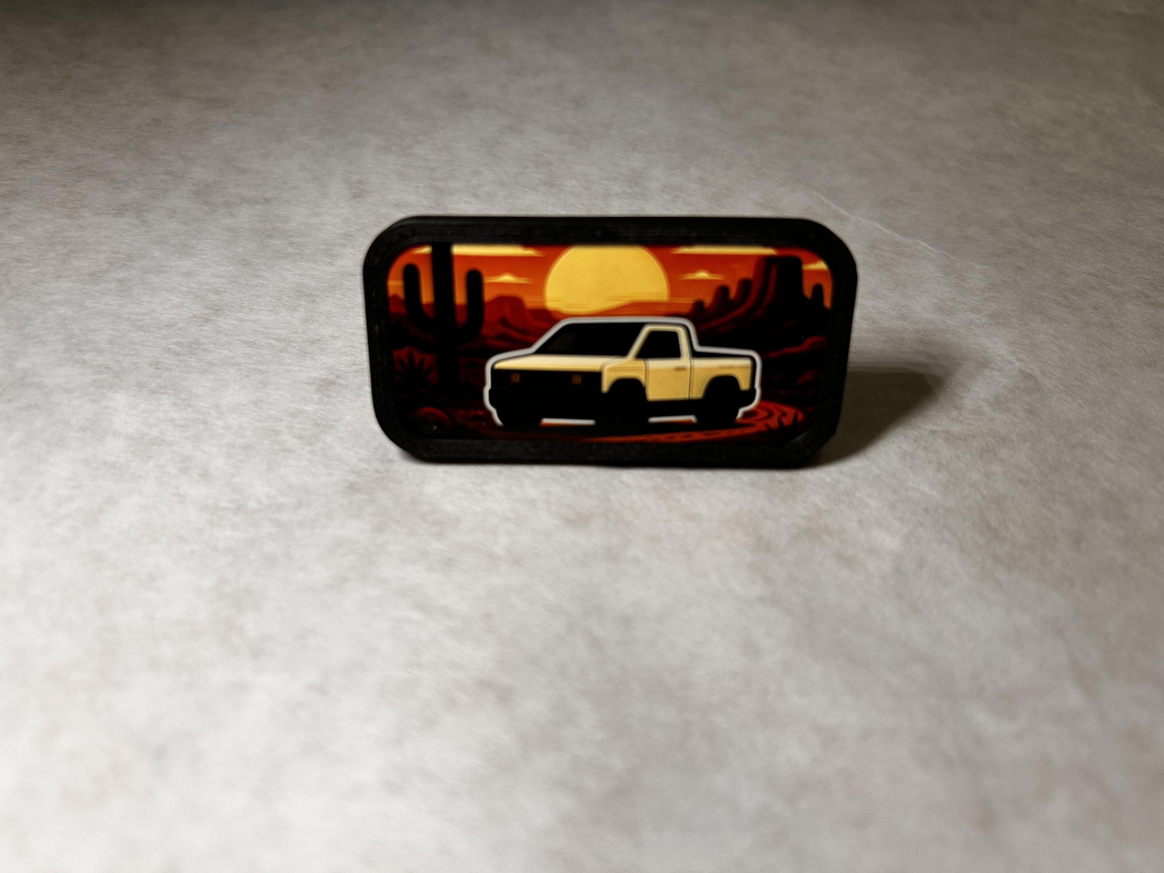 Front view of the Cool Set Dash Badge with the desert sunset truck sticker installed