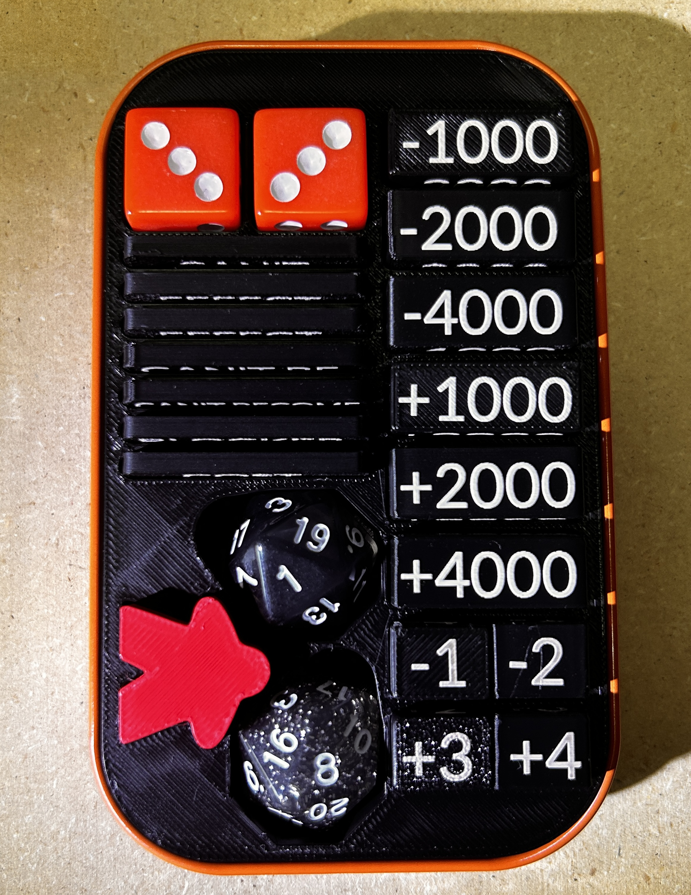 TinForge insert and included game pieces displayed inside a metal tin that is not included