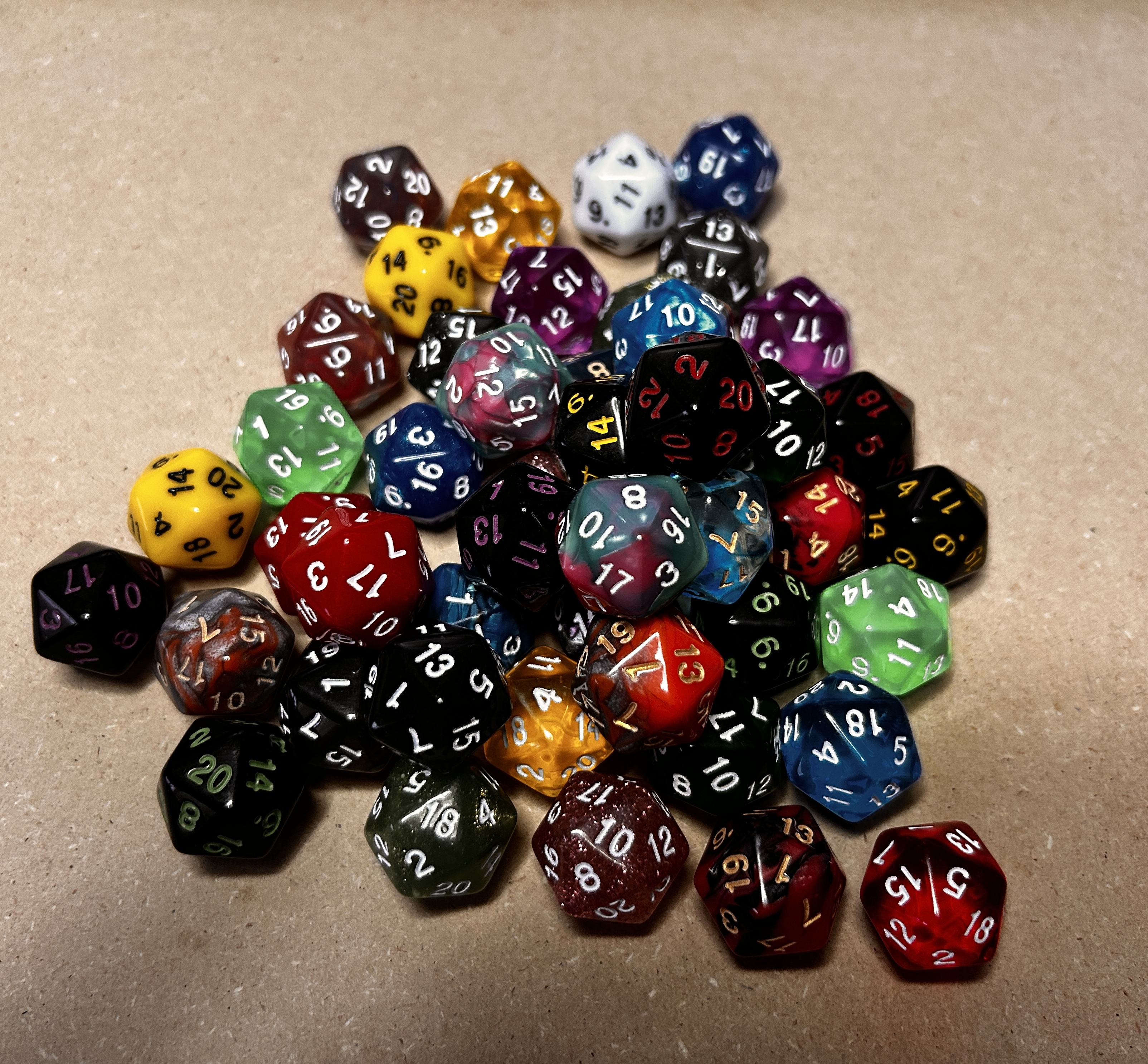 Collection of colorful 20-sided dice used as a D20 sizing reference