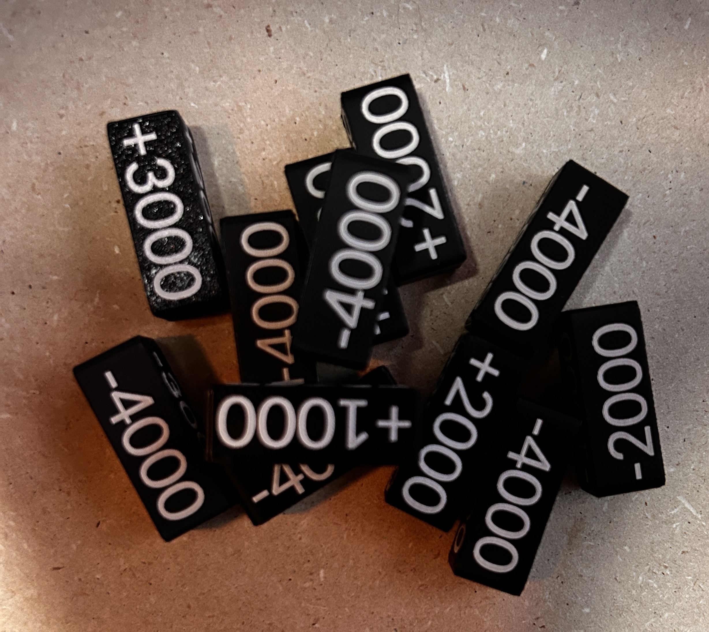Black and white 3D-printed damage counters for tabletop games