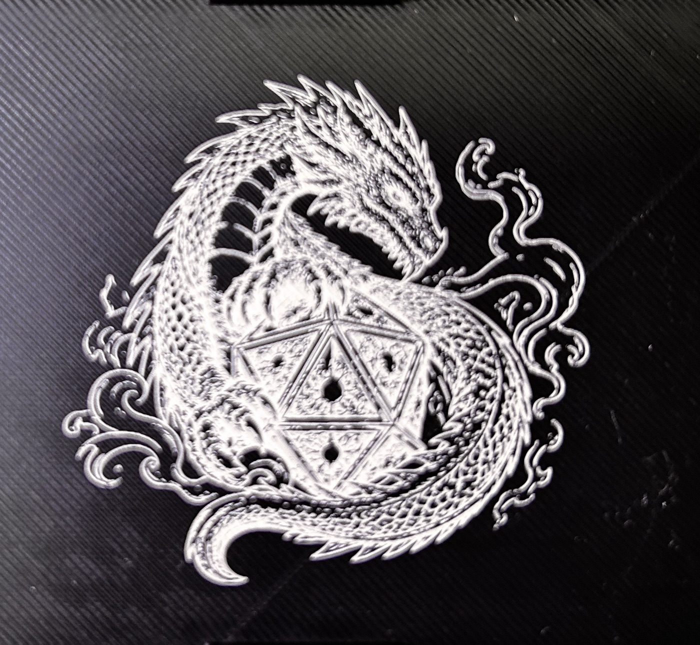 Dragon laser graphic on black printed plastic
