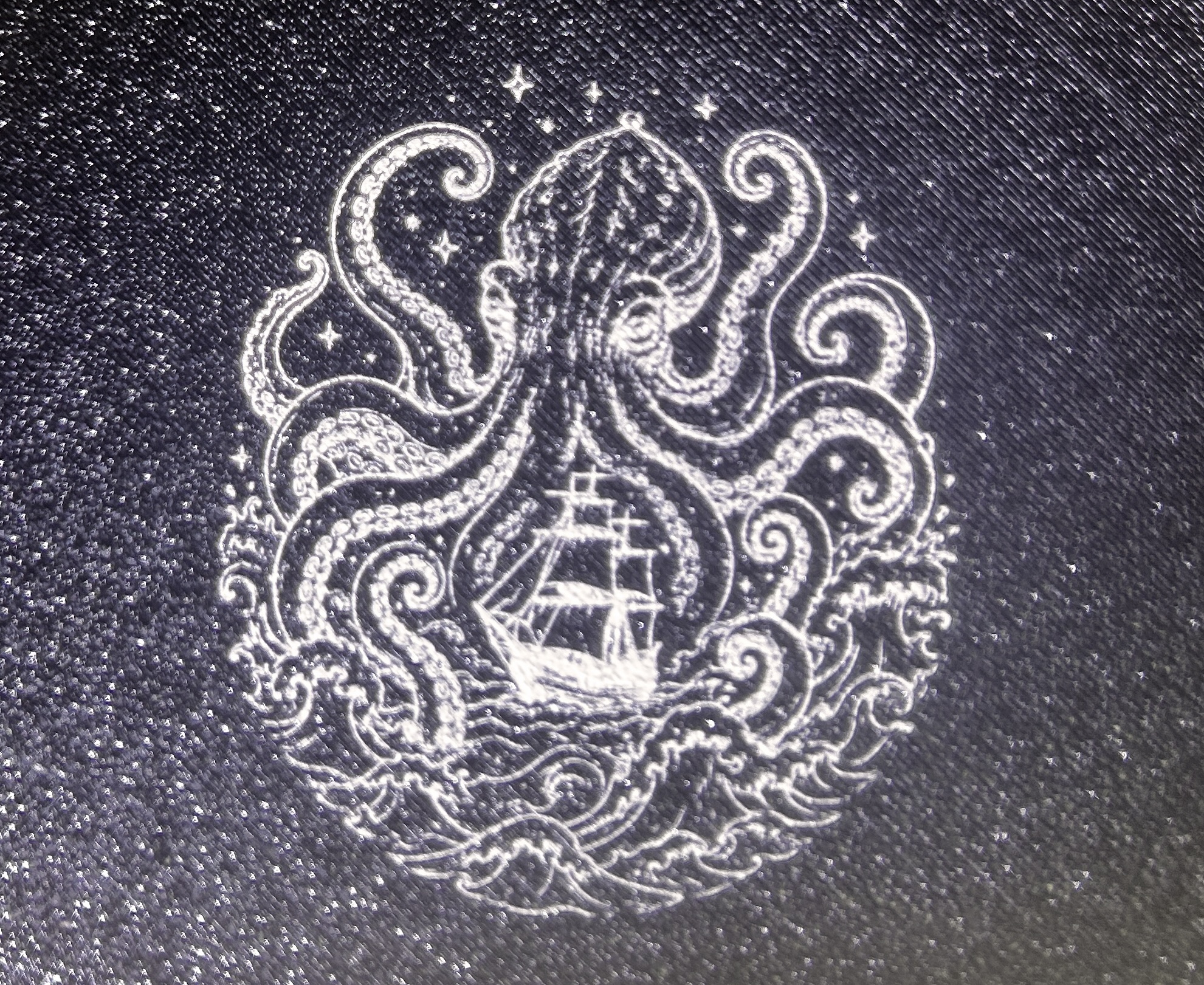 Squid laser graphic on black printed plastic
