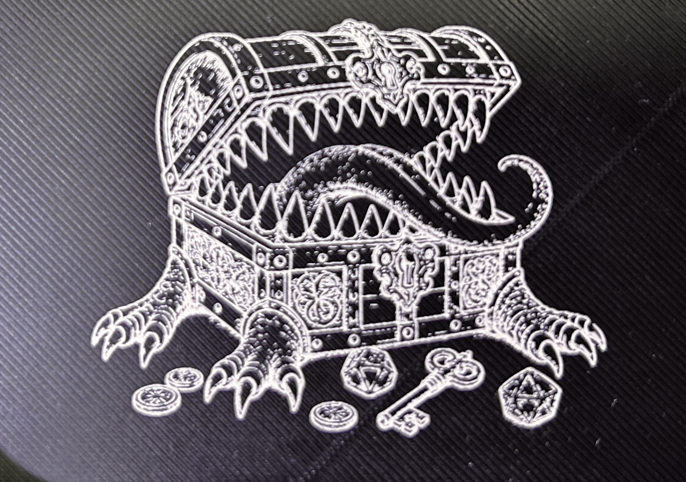 Treasure Chest laser graphic on black printed plastic