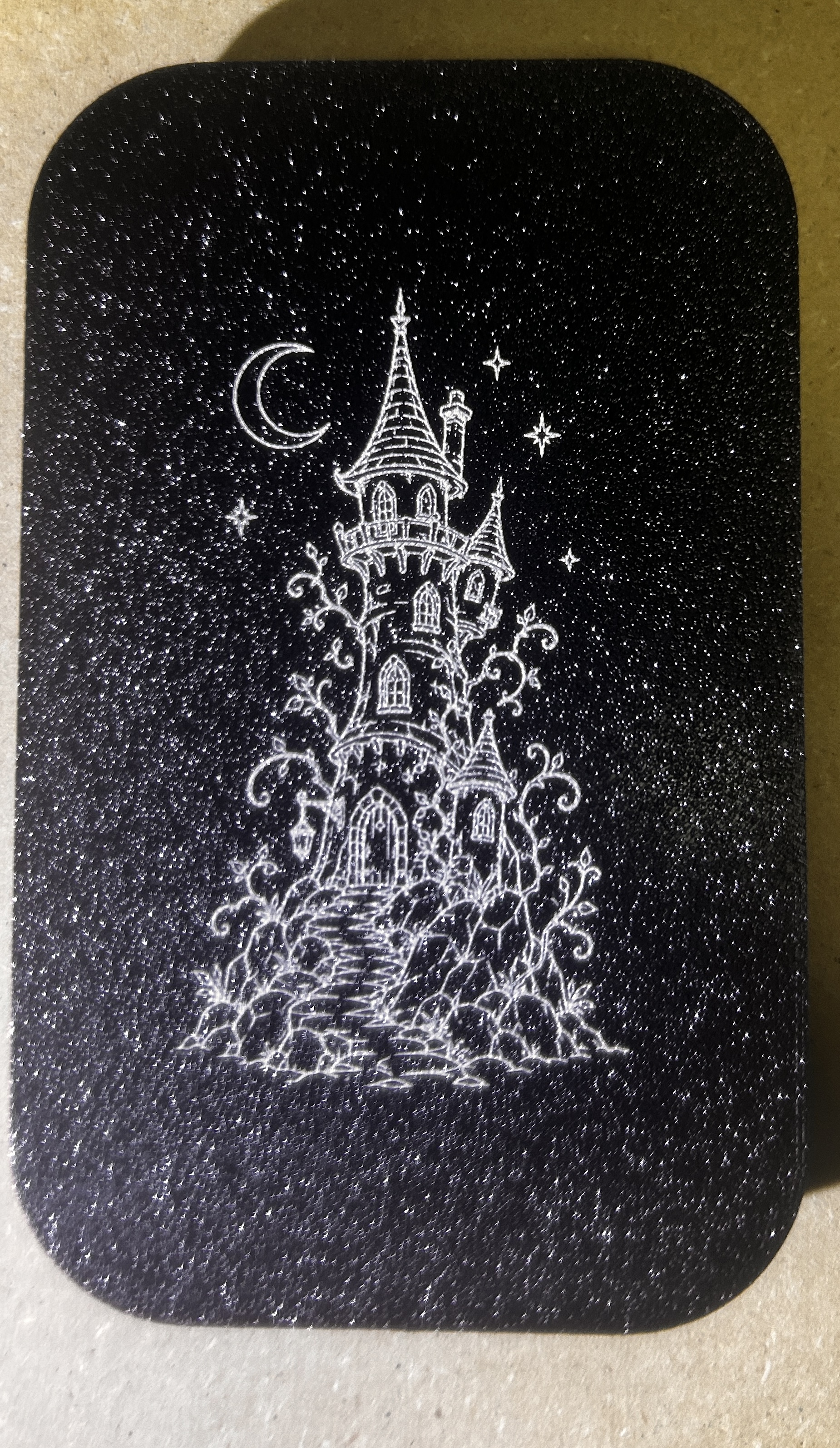 Wizard Tower laser graphic on black printed plastic