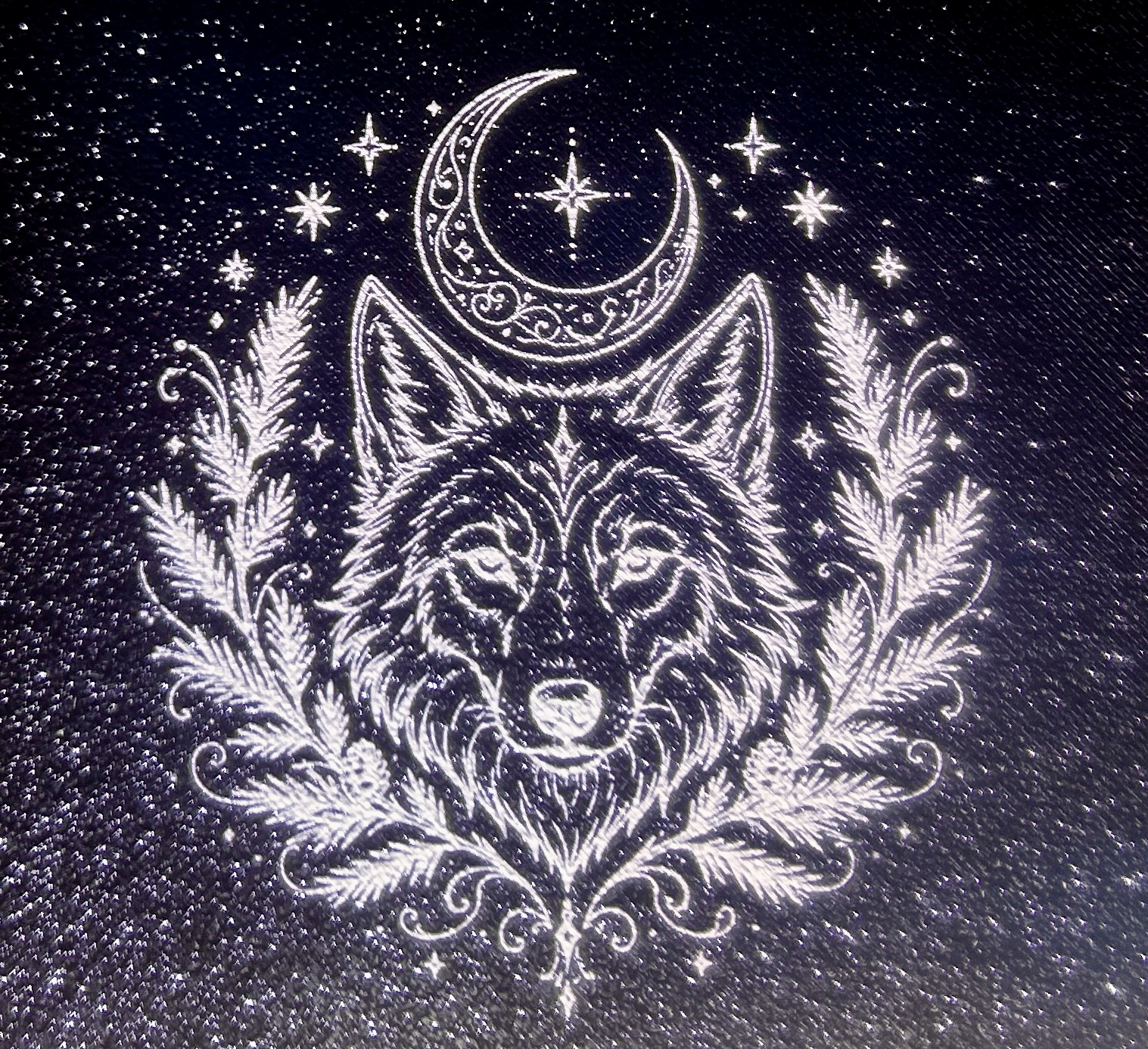 Wolf laser graphic on black printed plastic